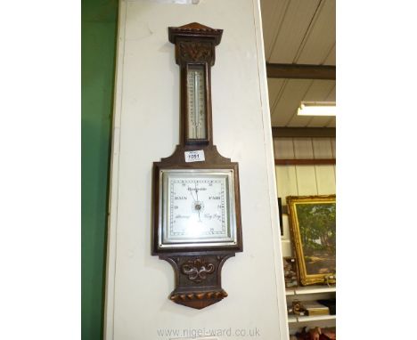 An Oak carved wall mounted barometer with stylish square central glass face and temperature gauge, 23" long.