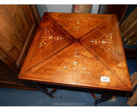 A good Edwardian Mahogany and Rosewood Envelope Table, the leaves nicely inlaid with swags and leaf scrolls, each lifting to 