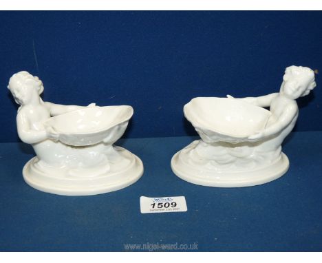 A pair of Royal Worcester porcelain Mermaid children salt cellars, 5" x 4" tall.