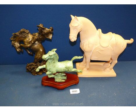 A large ceramic terracotta coloured horse plus a metal figure of a running horse with green glaze on wooden plinth, plus a re