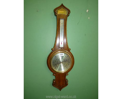 A banjo Barometer by Comitti of London; presented to E.J. Broad by Wiggins &amp; Co for 25 years service. 26" long.