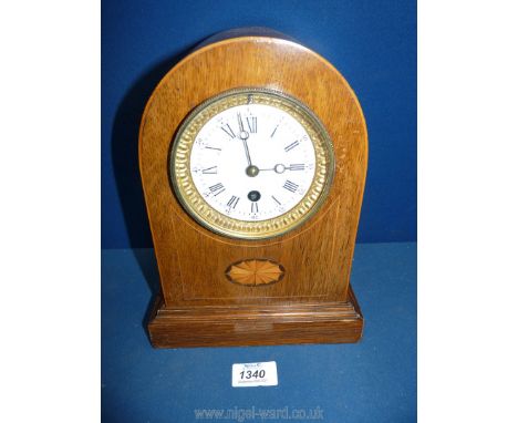 An elegant bracket/Mantle Clock having a single train movement, the white face with Roman hour numerals and Arabic minutes wi