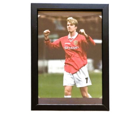 Football, David Beckham signed 13x10inch framed colour photo pictured while playing for Manchester United. Good condition. Al