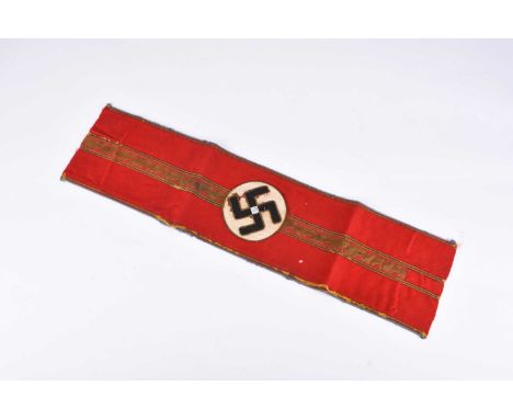 A German Third Reich NSDAP Ortsgruppenleiter Armband (1939-45)constructed of red cotton with a centred black ribbed swastika 