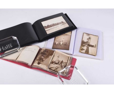 Three small albums of First World War and immediate post-war photographs and photographic postcards, including seventeen take