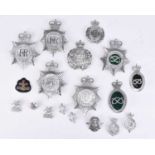 A group of police helmet plates and badges