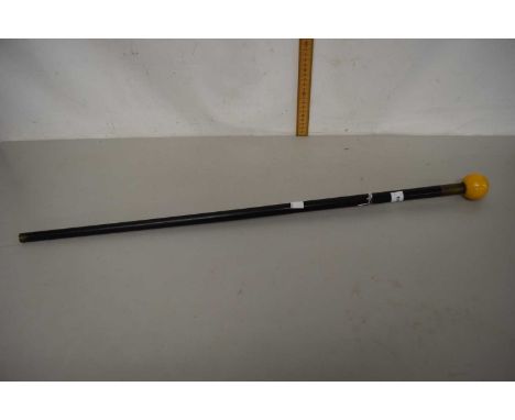A vintage ebonised walking stick with an amber coloured resin ball finial