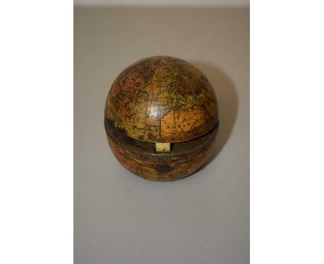 A small travelling ink well formed as a globe, the hinged lid opening to an interior with two ink wells and a brush wipeouter