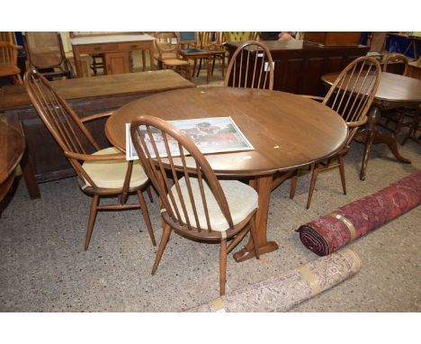 An Ercol drop leaf dining table together with four stick back dining chairs