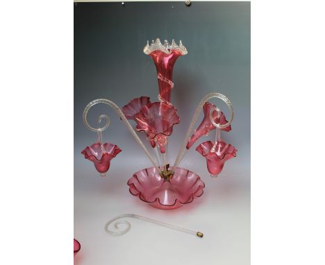 A LARGE VICTORIAN CRANBERRY GLASS EPERGNE, central frilled bowl and tall trumpet vase, with three further vases, two canes an