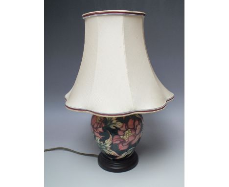 A MOORCROFT TRIAL PATTERN TABLE LAMP, green ground with pink floral and foliate pattern having typical tubeline decoration, H