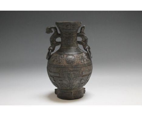 A BRONZE ARCHAISTIC TYPE HU VASE, having ornate swirl detailing and twin handles, H 21.5 cm