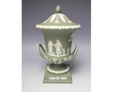 A WEDGWOOD GREEN JASPERWARE TWO-HANDLED CAMPANA-SHAPED URN AND COVER, having classical figural decoration to the body, raised