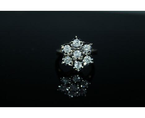 A 1 CARAT DIAMOND CLUSTER RING, having brilliant cut diamonds illusion set in hallmarked 9 carat gold, ring size L