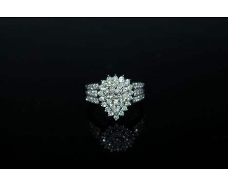 A 1 CARAT DIAMOND CLUSTER RING, having brilliant cut diamonds set in hallmarked 9 carat white gold, ring size L