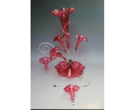 A VICTORIAN CRANBERRY GLASS EPERGNE, central frilled bowl and tall trumpet vase, with three further vases, two canes and two 