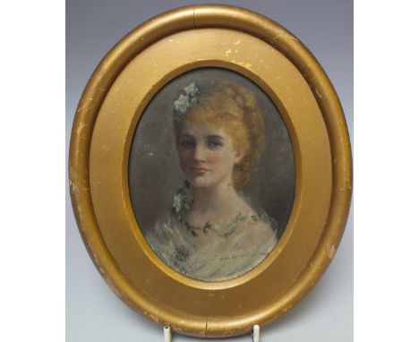 A LATE 19TH / EARLY 20TH CENTURY OVAL PORTRAIT MINIATURE OF A YOUNG WOMAN WITH FLOWERS IN HER HAIR, oil on board, unsigned, f