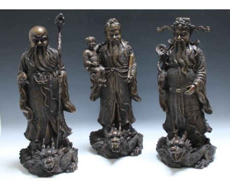 A SET OF THREE CHINESE BRONZE 'STAR GOD' DEITIES 'LU', 'FU' AND 'SHOU', 'Fu' - the symbol of good fortune depicted in scholar