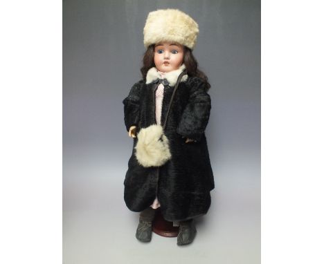 A LIMOGES BISQUE HEADED NO 7 DOLL, in period winter outfit, impressed marks to back of head 'Limoges, France', composite join