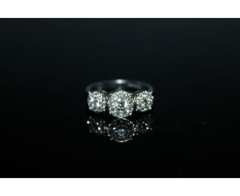 A HALLMARKED 18 CARAT WHITE GOLD DIAMOND CLUSTER TRILOGY RING, set with brilliant cut diamonds of approx 0.96 carat, ring siz