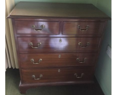 A MAHOGANY CHEST OF DRAWERS, with two short above three longer graduated drawers, original brass handles, raised on bracket f