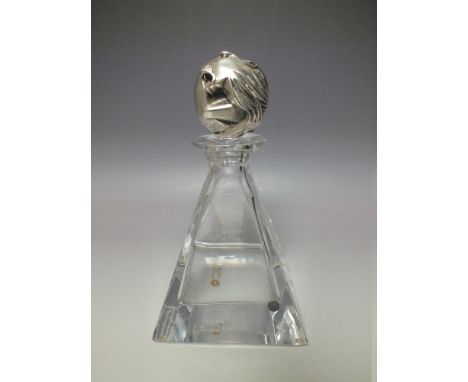 AN 'OTTAVIANI' HEAVY CRYSTAL DECANTER WITH SILVER LION HEAD STOPPER, the pyramid shaped glass body having metal seal, origina