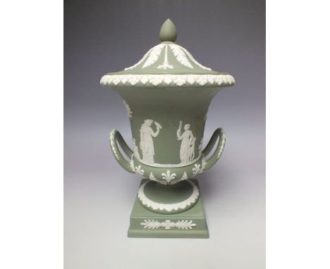 A WEDGWOOD GREEN JASPERWARE TWO-HANDLED CAMPANA-SHAPED URN AND COVER, having classical figural decoration to the body, raised