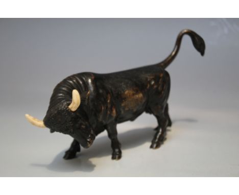 A 19TH CENTURY CAST BRONZE FIGURE OF A BULL, having painted definition to the eyes and mouth and painted horns, overall L 16 