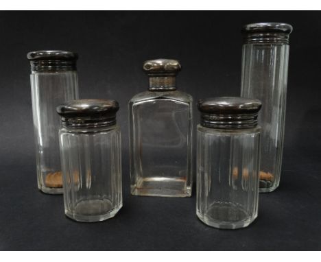 A George V silver engine turned set of five silver lidded glass toilet jars, each London 1920, weight of solid silver 1.45oz 