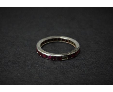 A white metal ruby set full eternity ring, size M, weight 3.8g approx. 