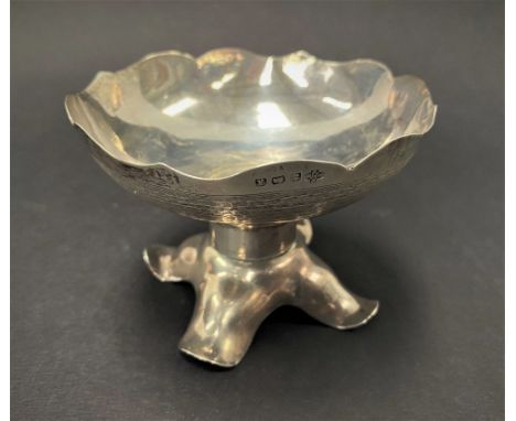 A George V silver engine turned pedestal bonbon dish, with wavy rim upon a weighted base with four outswept feet, maker Willi
