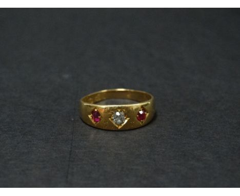A Victorian 18ct. hallmarked gold diamond and ruby set three stone gypsy ring, the diamond of 0.07ct. spread approx. flanked 