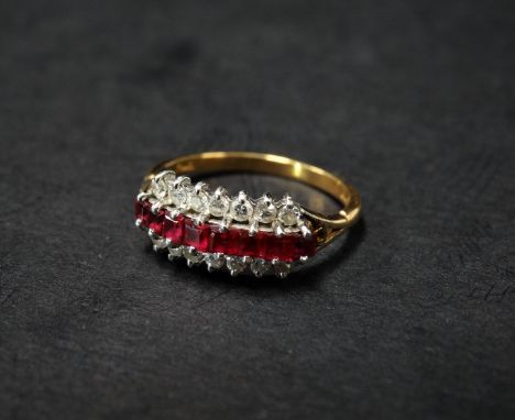 A modern 18ct. gold diamond and ruby twenty two stone half eternity ring, the eight rubies of square cut and each measuring 0