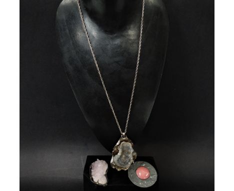 A Modernist white metal rose quartz geode mounted brooch, width 6.5cm, together with a white metal geode pendant necklace and