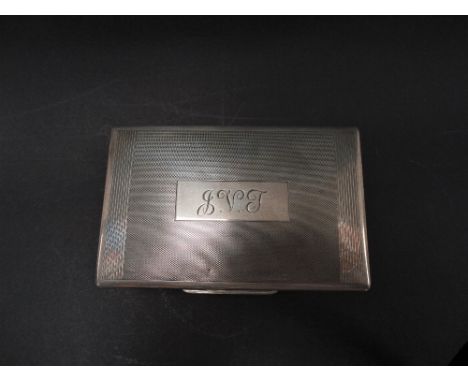 A George VI silver engine turned hinge lidded cigarette box with engraved monogram and dedication to the front, maker W.T.T &