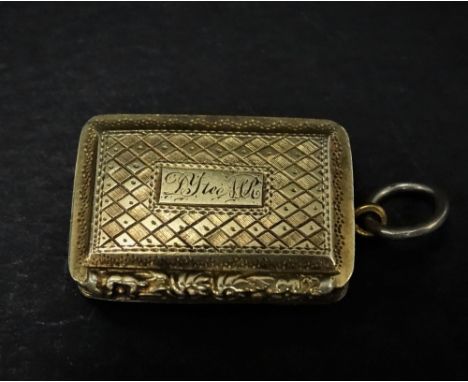 A George IV silver gilt engine turned vinaigrette fob, the hinge lid with engraved name and with foliate cast edge, hinged to