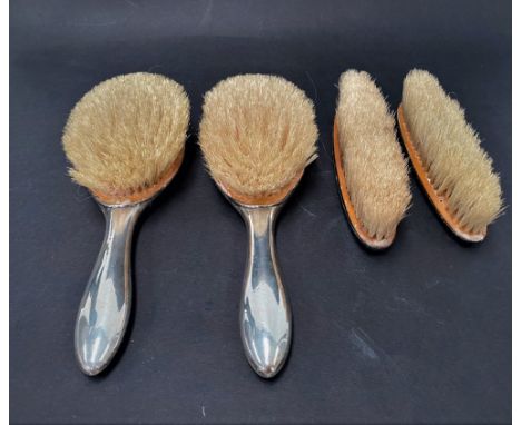A George V silver engine turned four piece dressing table set, with egg and dart edge, maker B &amp; Co., Birmingham 1928. 