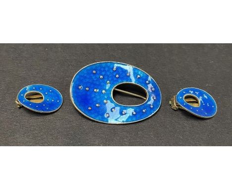 A mid 20th century Oystein Balle Norwegian silver gilt and guilloche enamel brooch and clip earrings set, the enamel of dark 