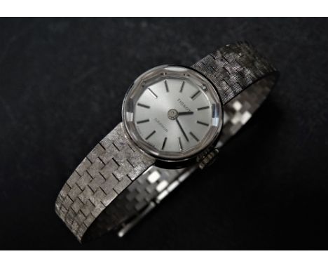 A ladies 18ct. white gold Tissot 'Saphir' manual wind cocktail bracelet wristwatch, the 7mm silvered dial with silver baton m