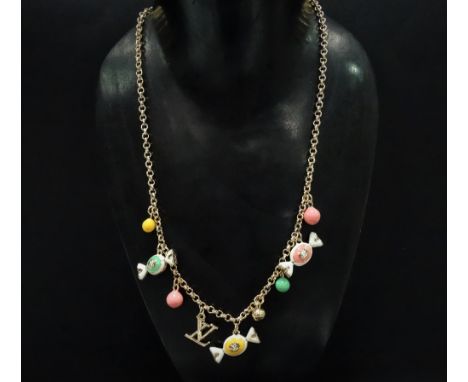A Yves Saint Laurent gold plated necklace set with nine enamel and gilt pendants, length 56cm.