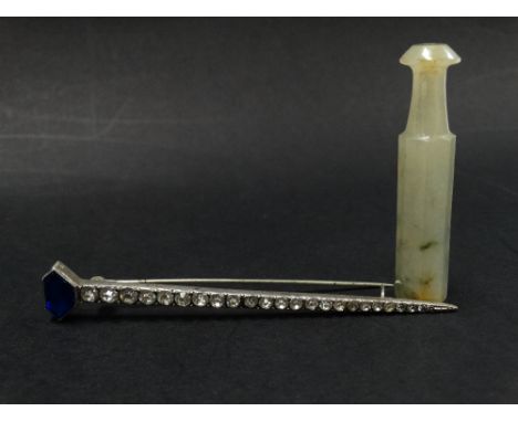 A celadon green jade cheroot holder, length 57mm, together with a paste set Art Deco brooch, length 9cm (2).  
