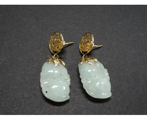 A pair of Chinese celadon jade 14ct. gold mounted drop earrings, the stud pierced with a coiling dragon, the jade carved and 