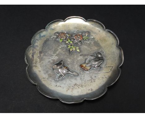 A Japanese silver and coloured enamel lobed pin dish, decorated with roses and two pigeons, raised on two supports (one suppo