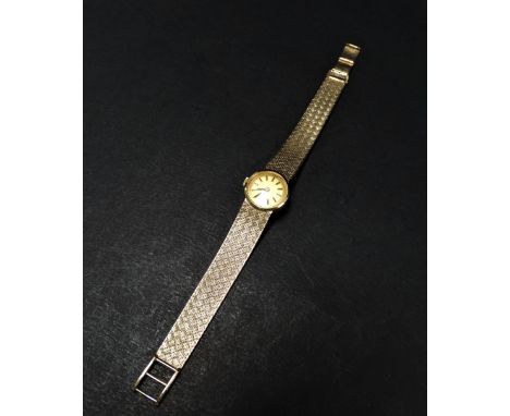 A Tudor ladies 9ct. hallmarked gold bracelet manual wind wristwatch, the 13mm champagne dial signed TUDOR and with baton mark