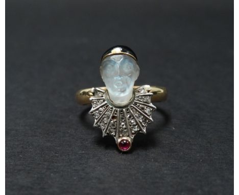 An unusual Victorian diamond ruby carved moonstone and black enamel mounted 9ct. gold ring modelled as a pierrot, the moonsto