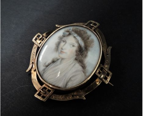 A good early 19th century yellow metal mounted oval portrait miniature of a young girl on ivory, the miniature measuring 42 x