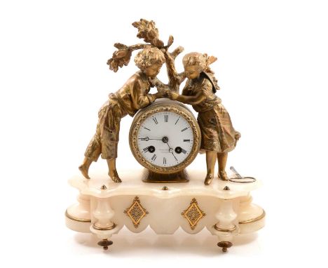 French gilt spelter and alabaster mantel clock, the case with a young couple and birds nest, circular dial signed for the ret