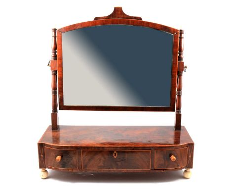 Georgian mahogany toilet mirror, arched plate, turned supports with turned ivory finials, the step-front base fitted with thr