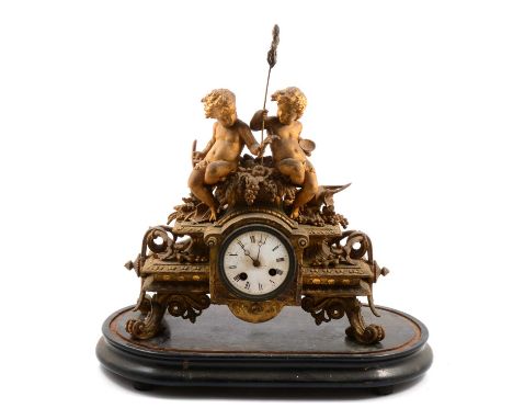 French gilt spelter mantel clock, the case with cherubs and scrolls, circular enamelled dial, cylinder movement striking on a