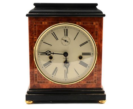 Kieninger mantel clock, inlaid burr wanlut and ebonised case, the movement striking on eight gongs, 28cm.